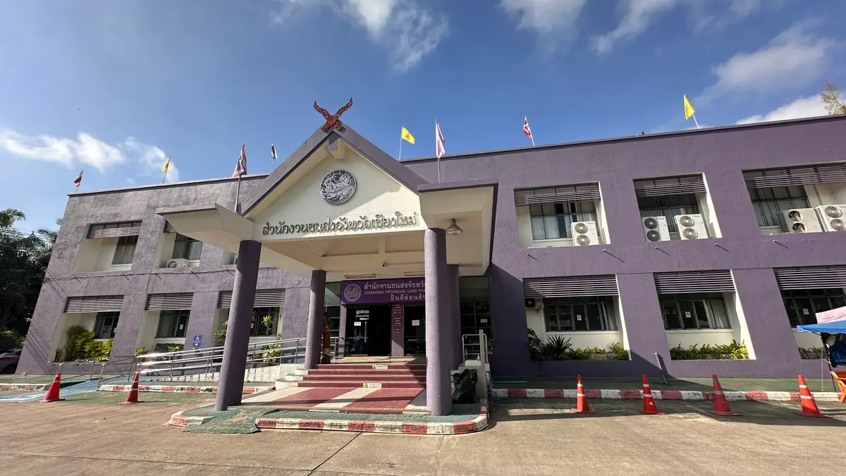 Front of the land transport office, a purple building with a Thai crest above the entrance.