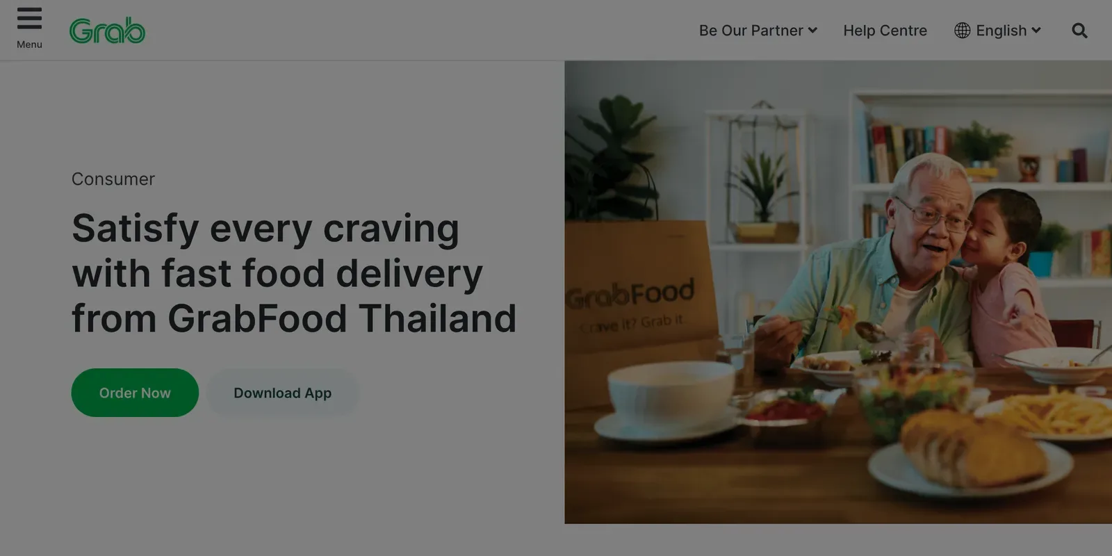 GrabFood page with a headline about fast food delivery beside a photo of a family eating at a table