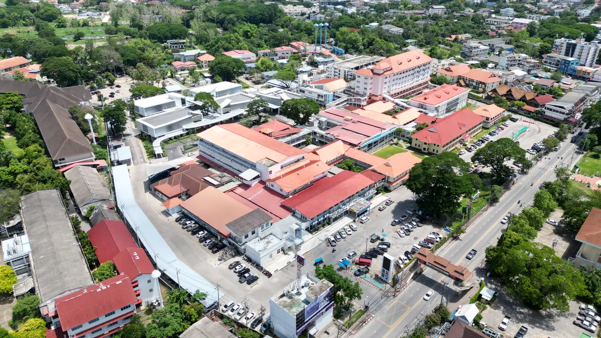 Aerial view of the McCormick Hospital campus with red tiled roofs and a car park.
