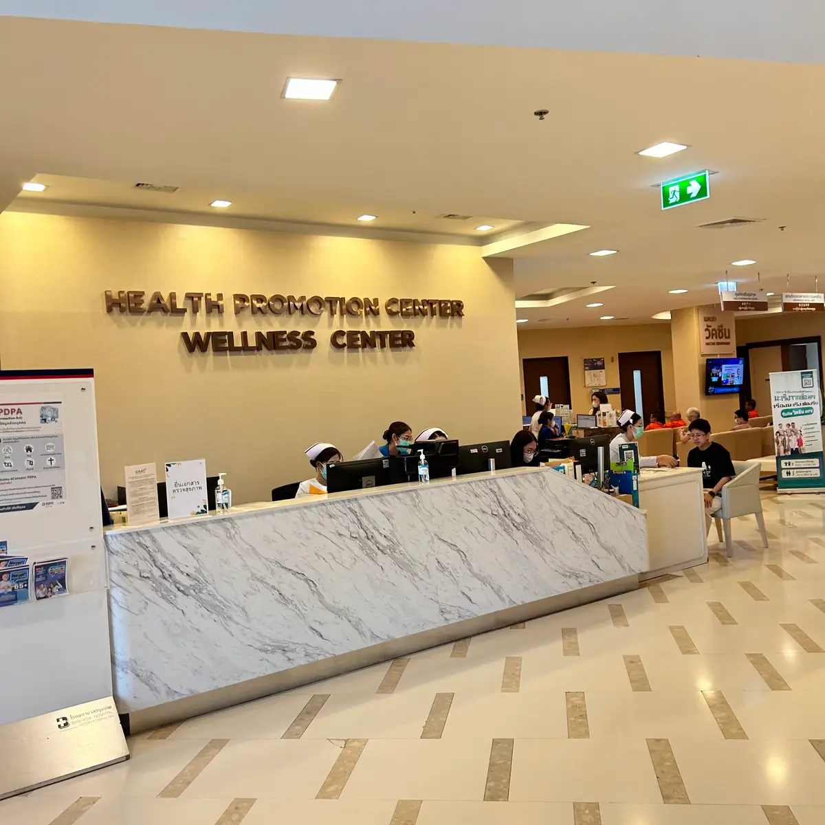 Wellness centre reception counter with a marble front and nurses behind it