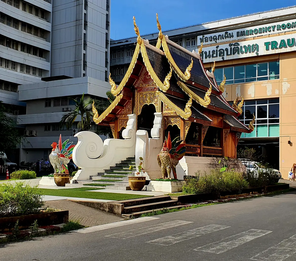 Lanna-style wooden pavilion in front of the hospital buildings at the emergency entrance