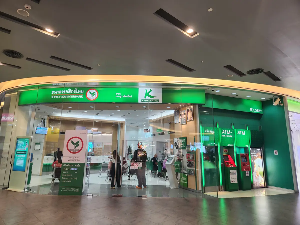 Green-fronted Kasikornbank branch inside a shopping mall with ATM machines to the right of the entrance.