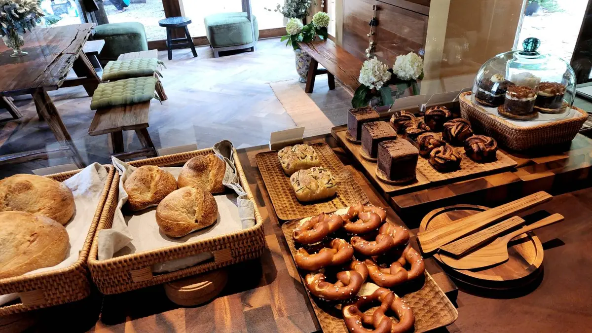 Bakery display of sourdough loaves, pretzels and brownies in wicker trays
