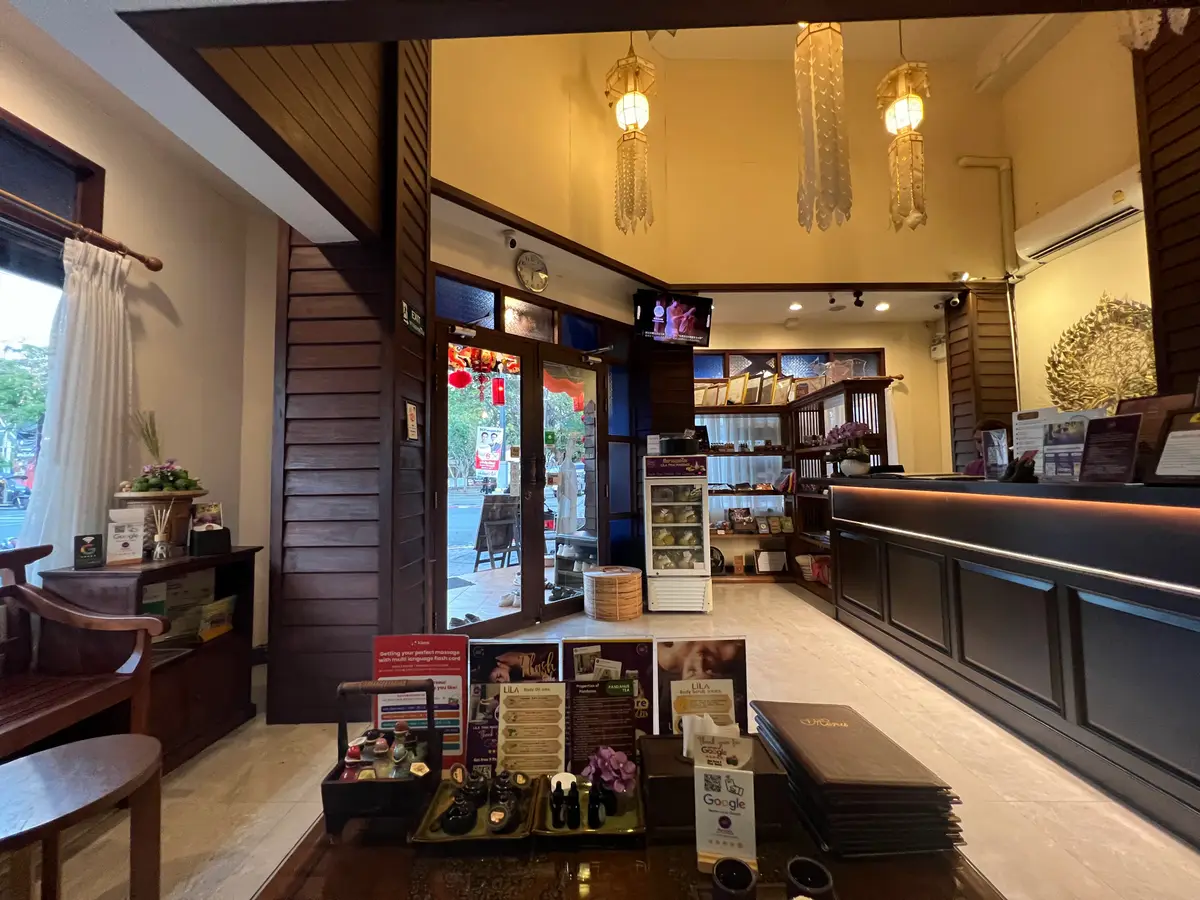 A wood-panelled reception lobby with shelves of products and a counter on the right.