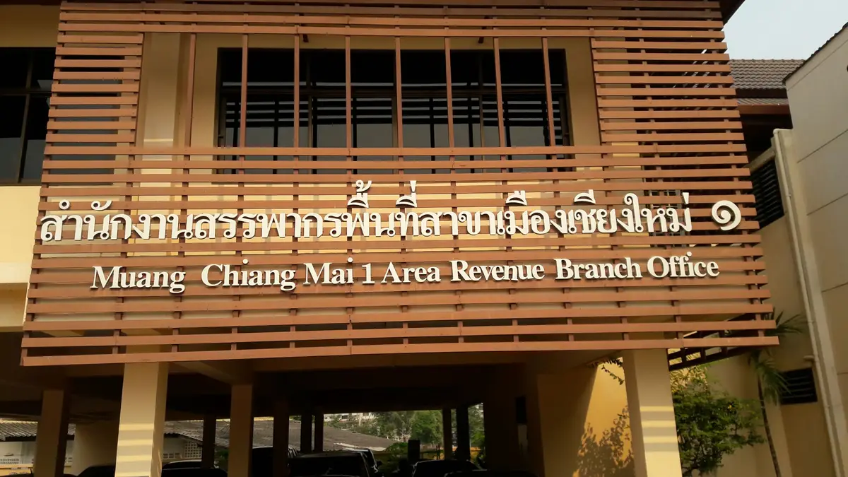 Wooden facade of a Revenue Department office with its English name sign across the upper wall.